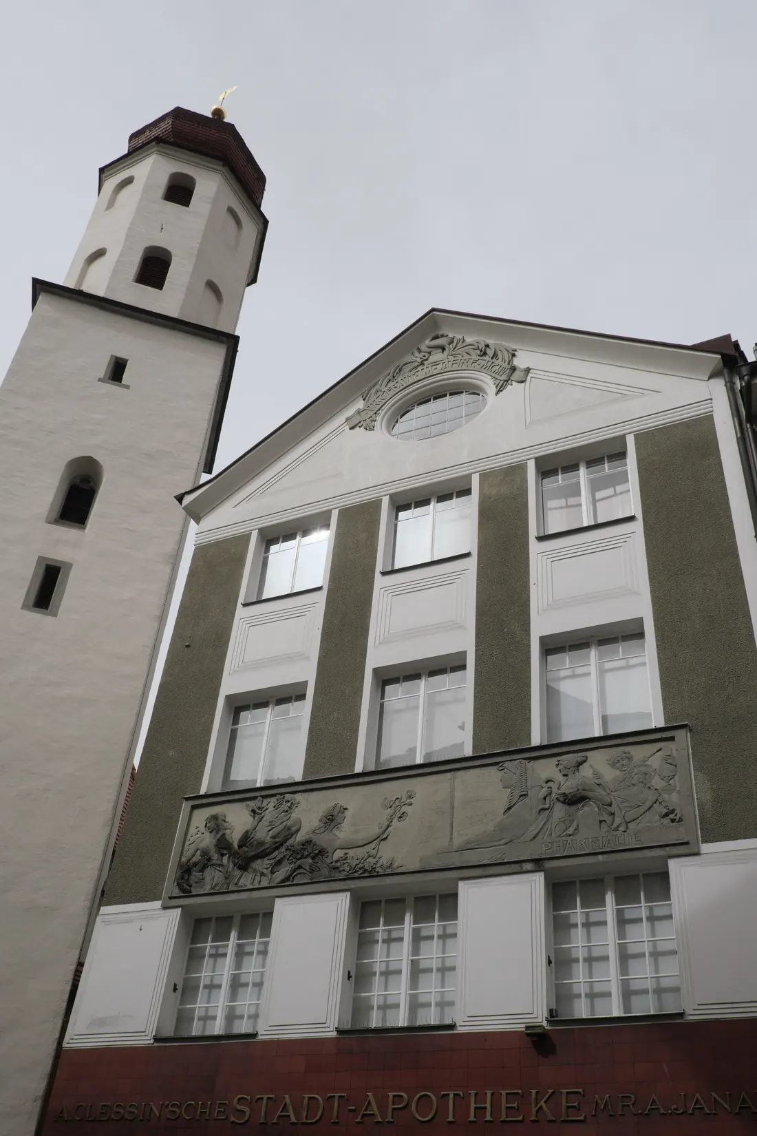 Die Jugendstil-Fassade der Stadt-Apotheke von unten gesehen, links der Turm der Frauenkirche in Feldkirch